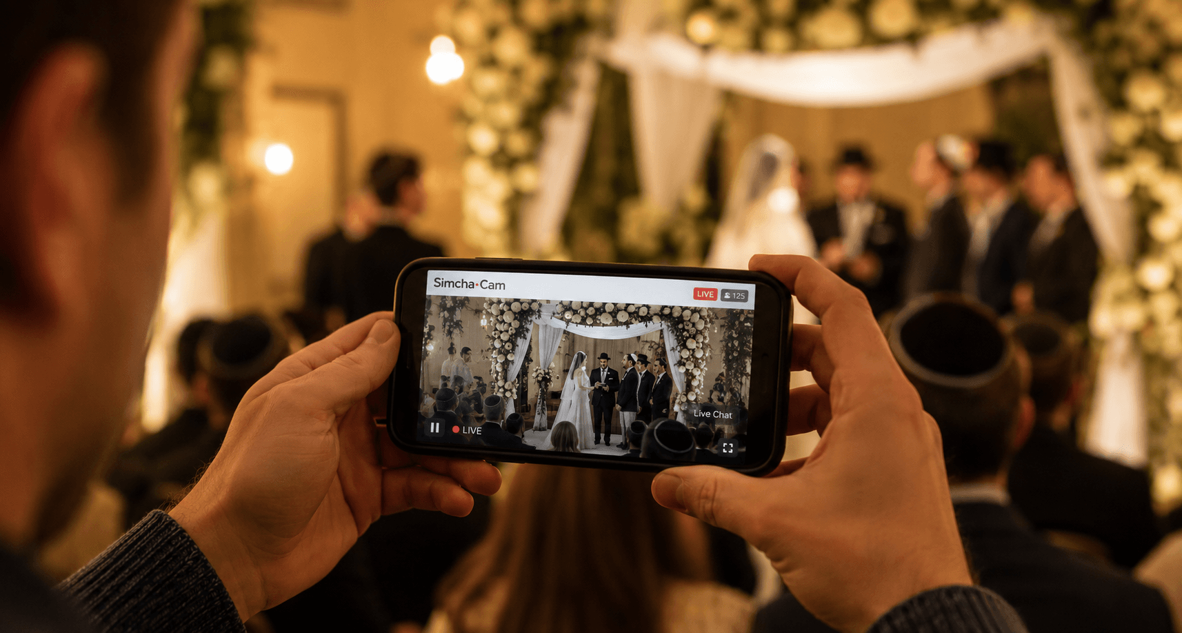 A wedding chuppah being livestreamed to family through a phone